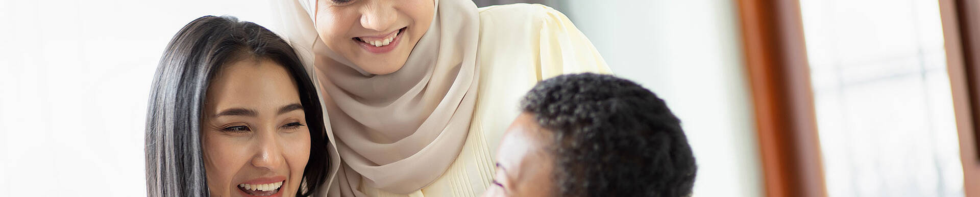 Foto: Drei Personen mit Migrationshintergrund