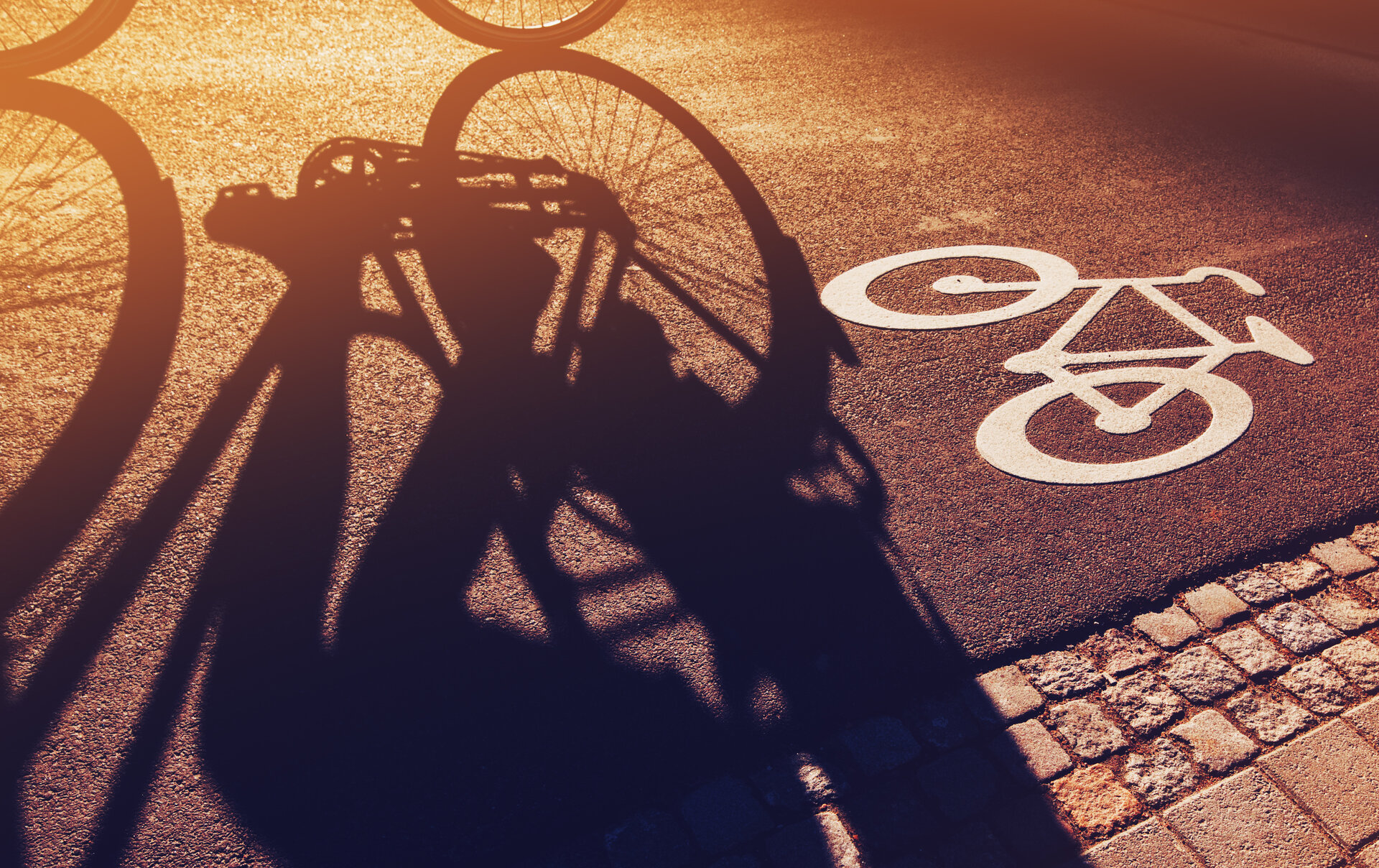 Schatten eines Fahrads auf einem Radweg
